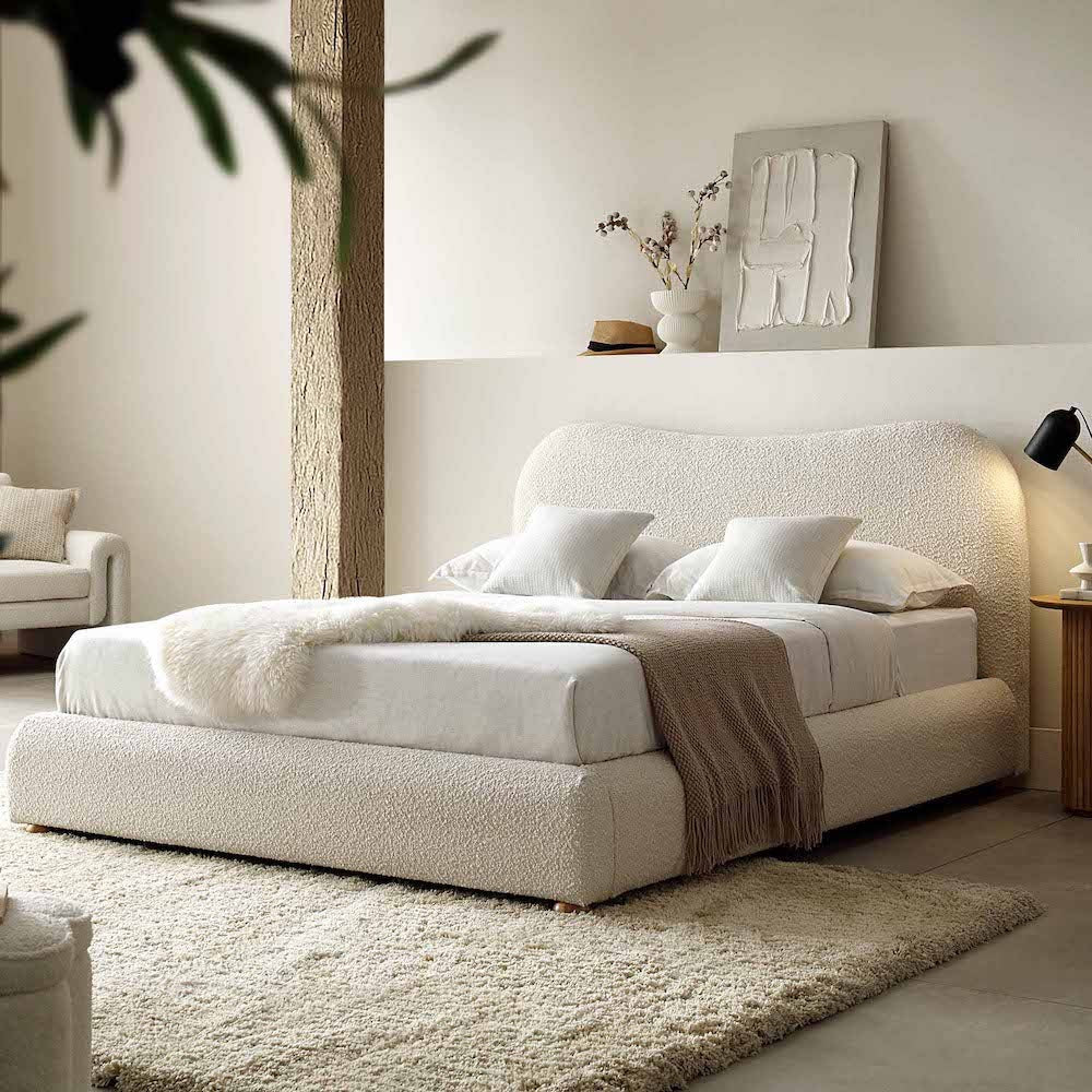 A bed with mattress cream colour