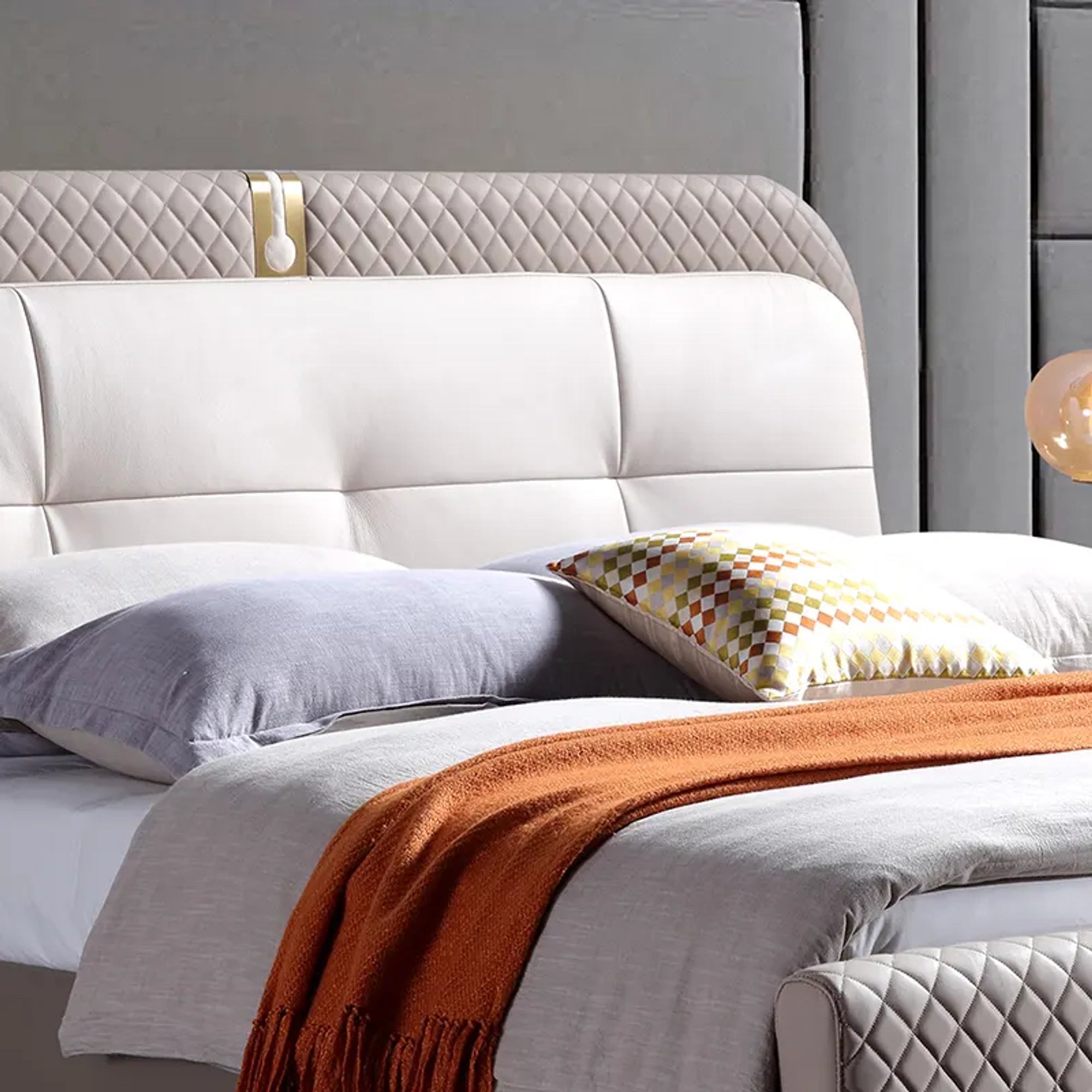 A bed with mattress grey and white colour