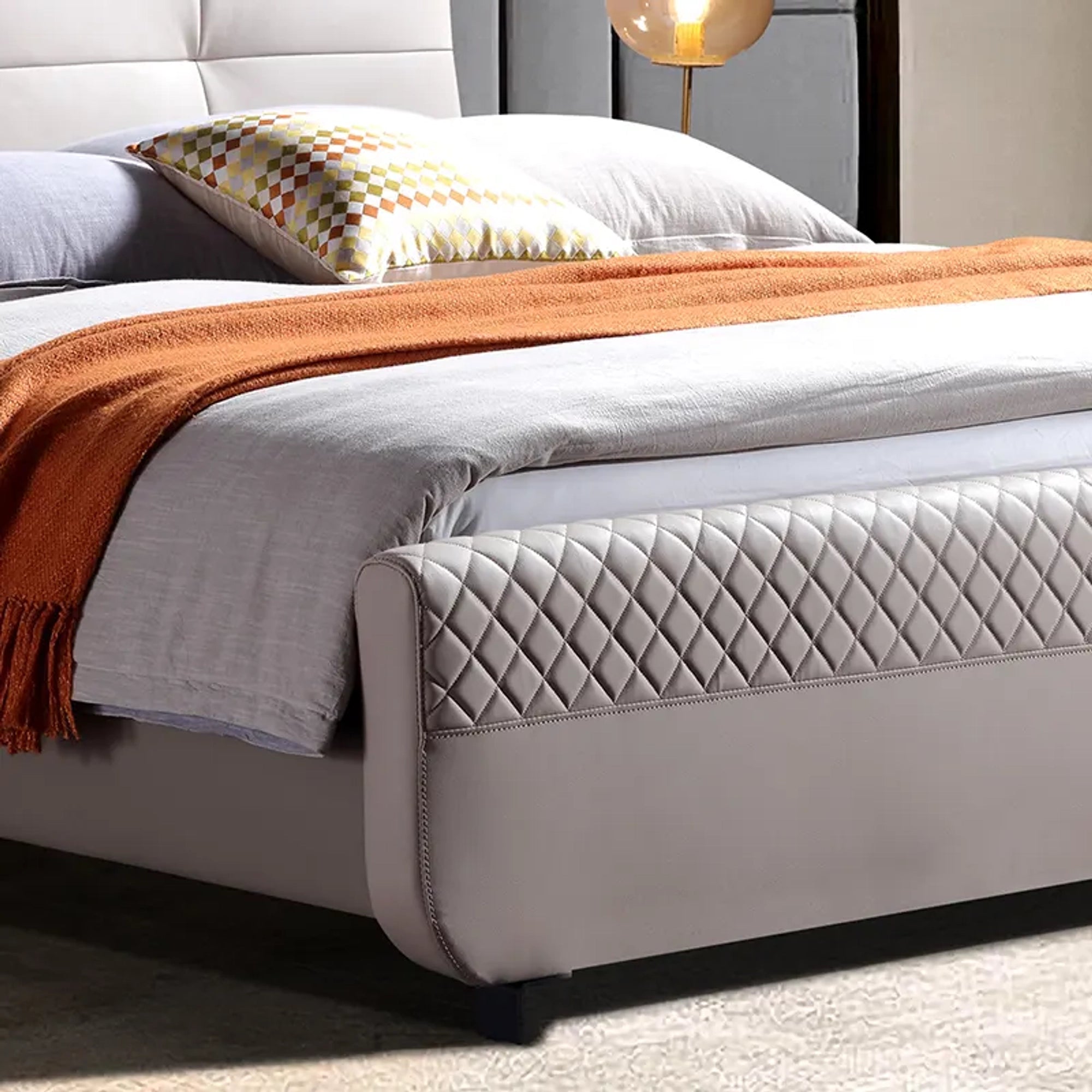 A bed with mattress grey and white colour