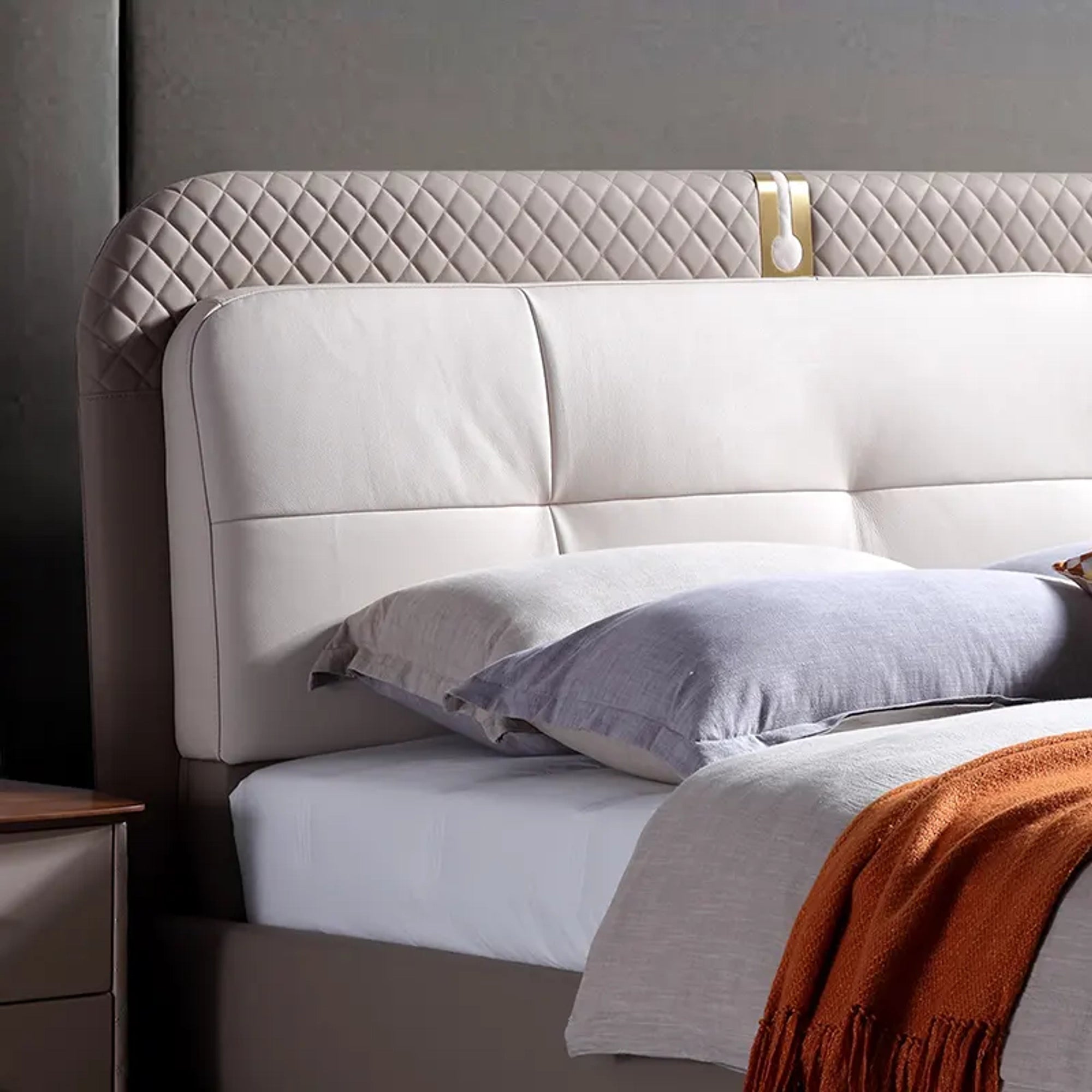 A bed with mattress grey and white colour